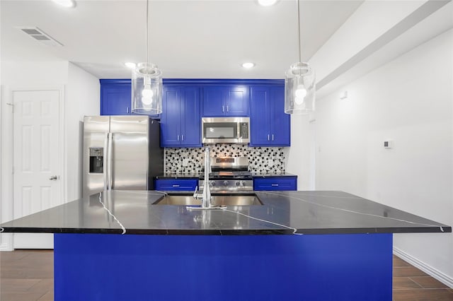 kitchen with decorative light fixtures, a large island, blue cabinetry, and appliances with stainless steel finishes