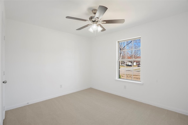 empty room with ceiling fan and carpet