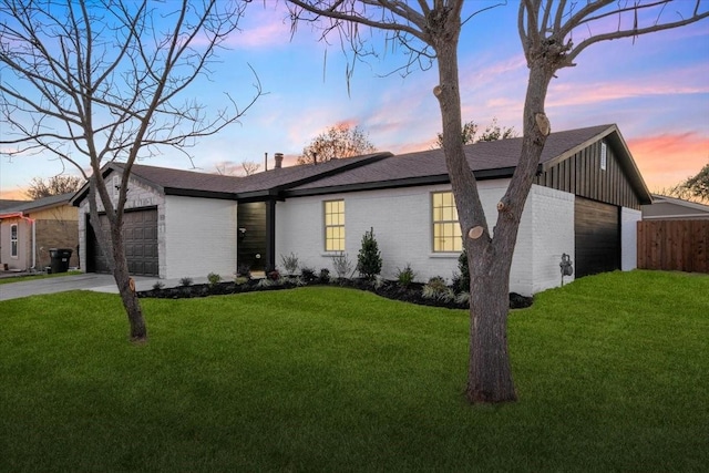 ranch-style home with a yard and a garage