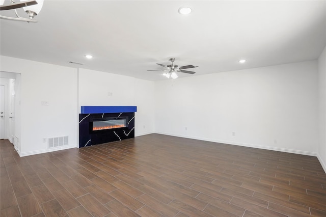 unfurnished living room with ceiling fan