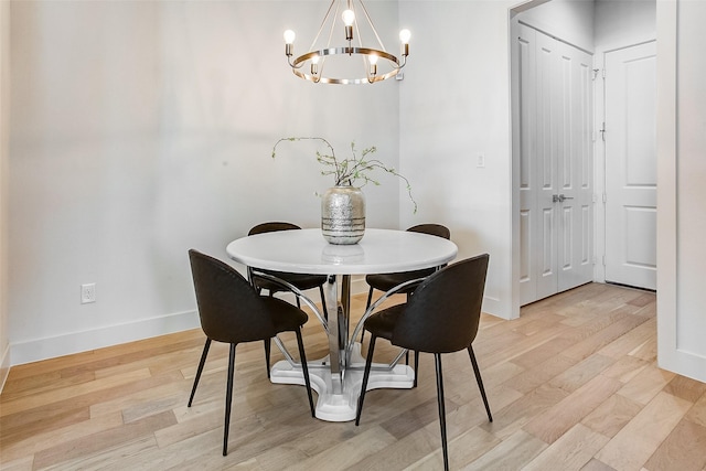 dining room featuring a chandelier and light wood-type flooring