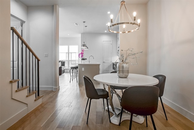 dining area featuring sink and light hardwood / wood-style flooring