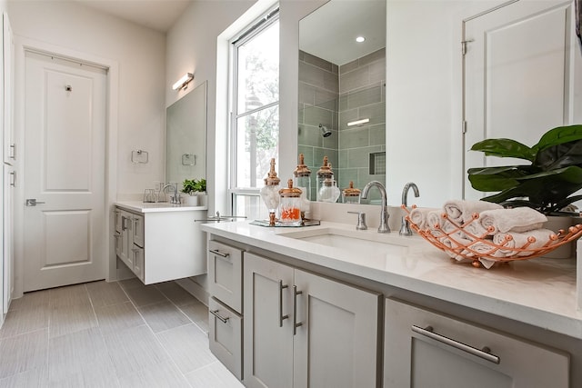 bathroom featuring vanity, tile patterned floors, and walk in shower