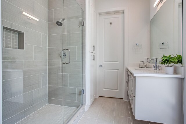 bathroom with vanity and a shower with shower door