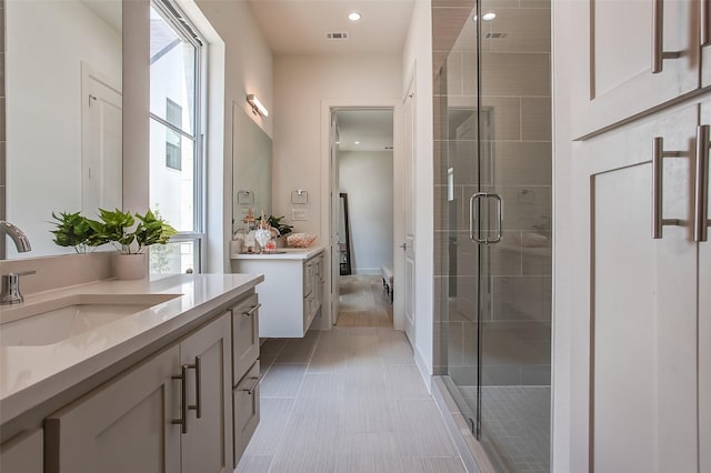 bathroom featuring an enclosed shower, vanity, and tile patterned floors