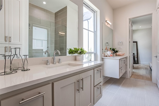 bathroom featuring tile patterned flooring, vanity, and a shower with shower door