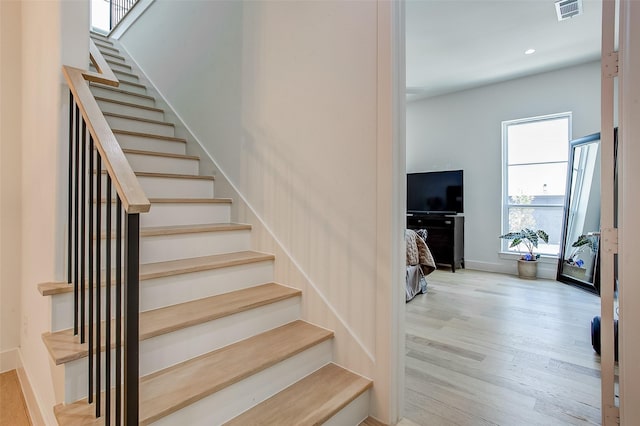 stairway with hardwood / wood-style flooring