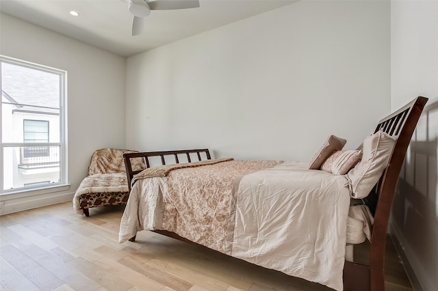 bedroom with light hardwood / wood-style flooring and ceiling fan