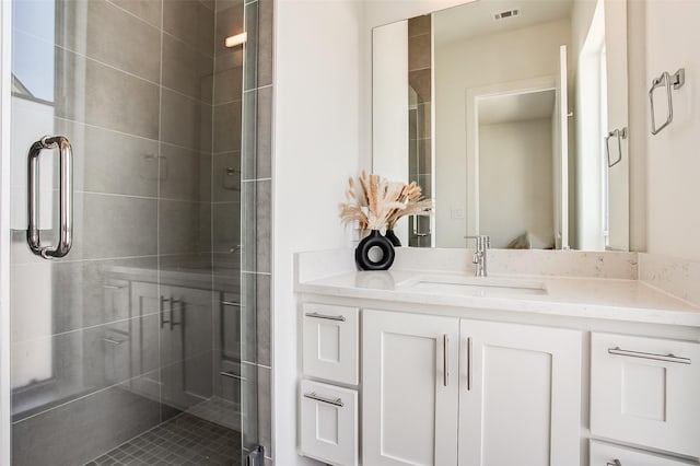 bathroom featuring vanity and an enclosed shower