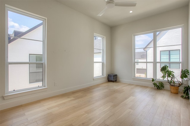 unfurnished room with ceiling fan and light wood-type flooring