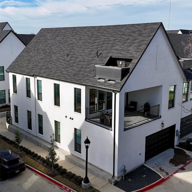 view of front of house with a garage and a balcony