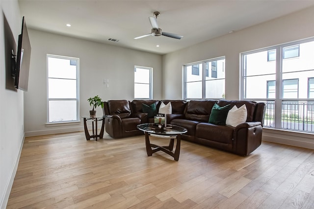 living room featuring ceiling fan and light wood-type flooring