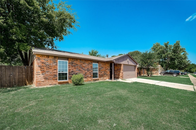 ranch-style house featuring a front yard and a garage