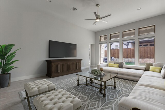 living room featuring ceiling fan and light hardwood / wood-style floors