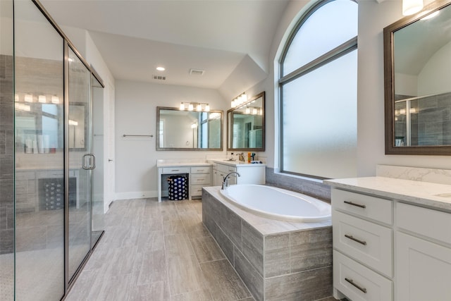 bathroom featuring vanity and shower with separate bathtub