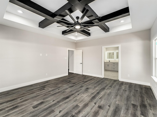 unfurnished bedroom with ensuite bathroom, beamed ceiling, dark hardwood / wood-style floors, and coffered ceiling