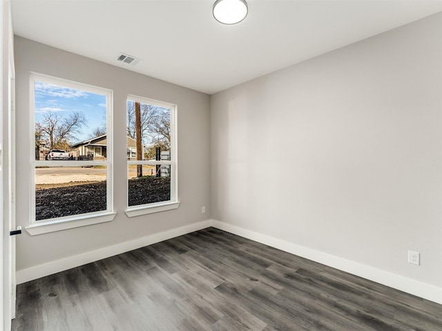 empty room featuring dark hardwood / wood-style flooring