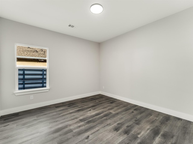 spare room with dark wood-type flooring