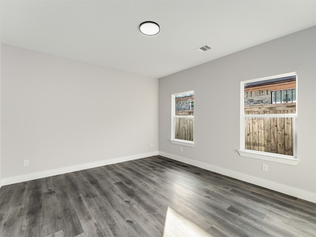 spare room with dark wood-type flooring