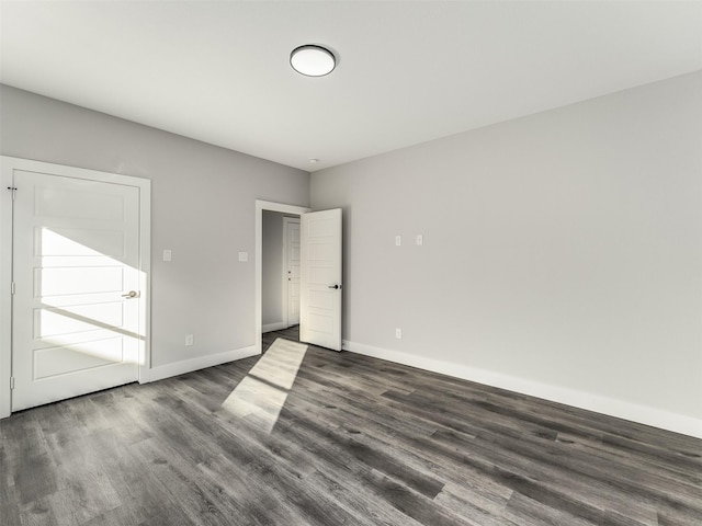 spare room with dark hardwood / wood-style floors