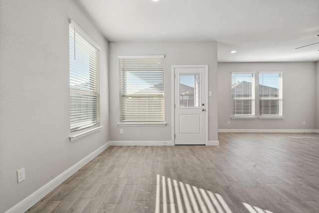 empty room featuring ceiling fan and light wood-type flooring