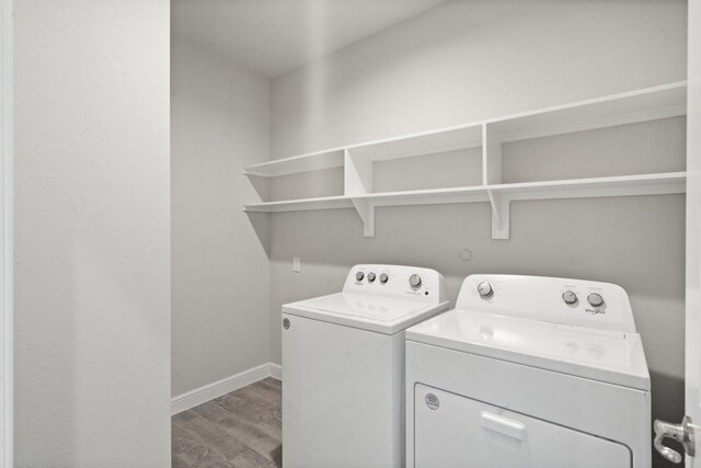 laundry area featuring hardwood / wood-style floors and washing machine and clothes dryer