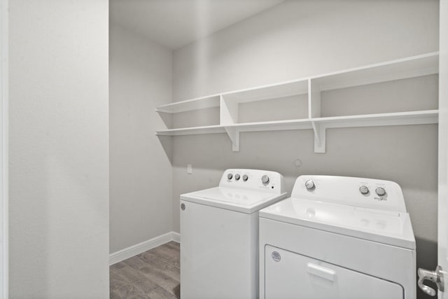 washroom with separate washer and dryer and hardwood / wood-style floors