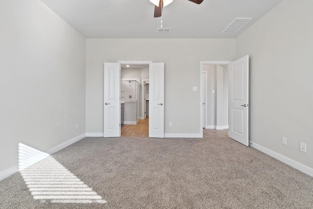 unfurnished bedroom with ceiling fan and light colored carpet