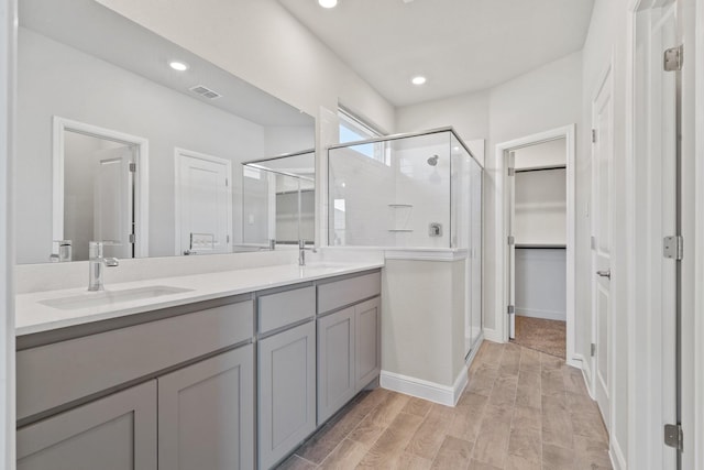 bathroom featuring vanity, hardwood / wood-style floors, and walk in shower