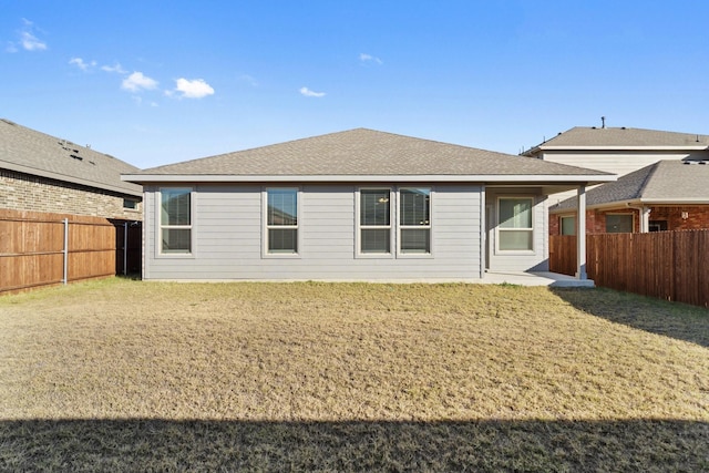 back of house featuring a yard