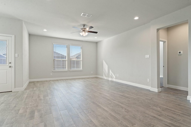 unfurnished room with ceiling fan and light wood-type flooring