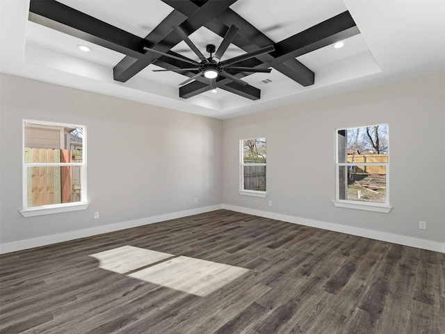 empty room with dark hardwood / wood-style floors, a healthy amount of sunlight, ceiling fan, and coffered ceiling