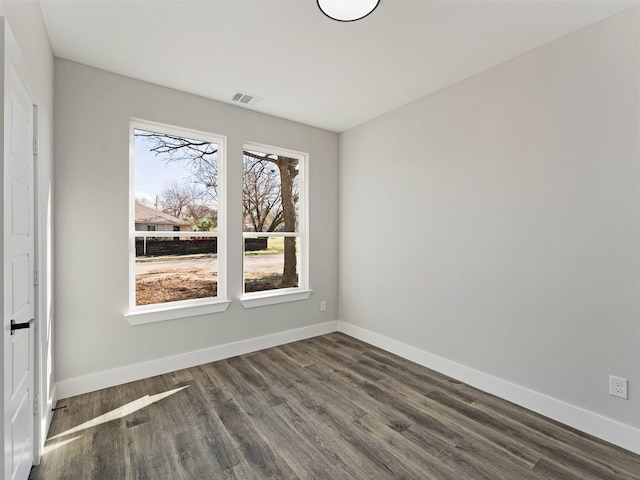 spare room with dark wood-type flooring