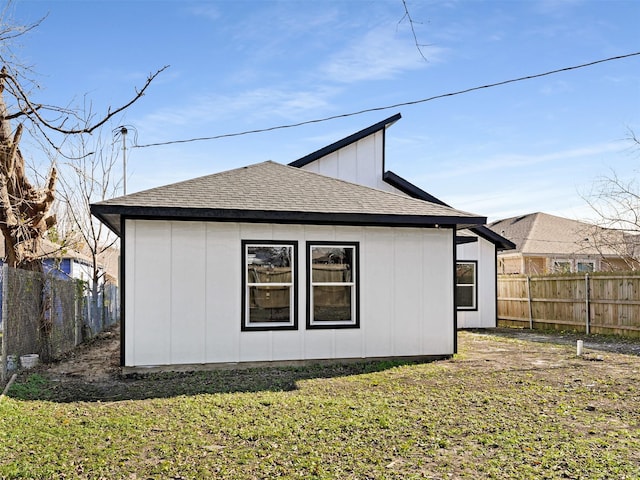 view of side of home featuring a lawn