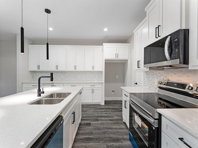 kitchen with sink, light stone counters, pendant lighting, white cabinets, and appliances with stainless steel finishes