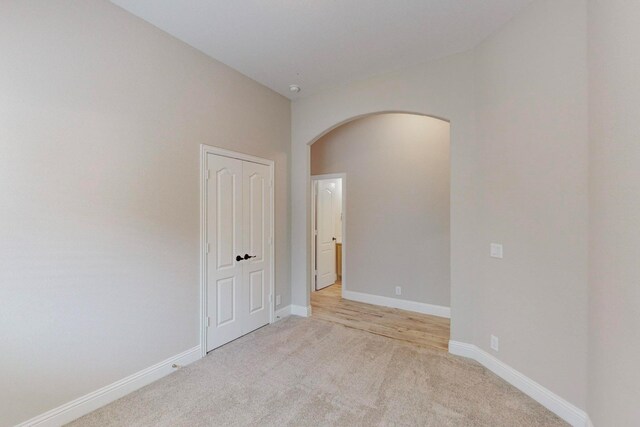 spare room featuring light colored carpet