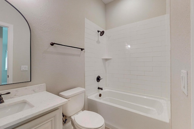 full bathroom featuring vanity, tiled shower / bath combo, and toilet