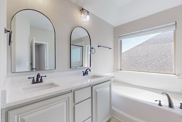 bathroom with vanity and a bathtub