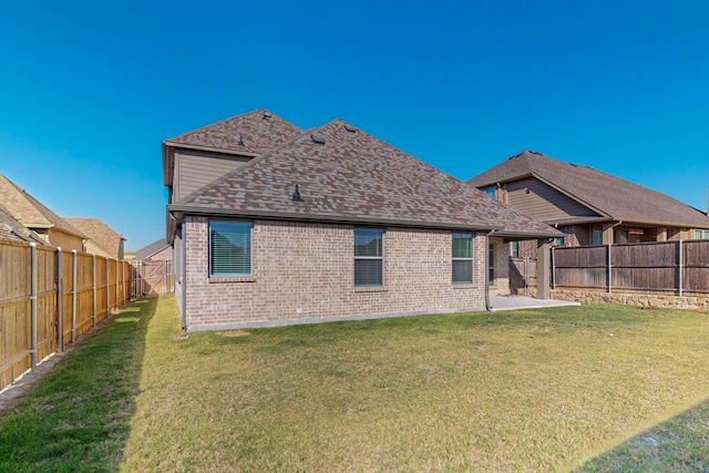 rear view of property featuring a lawn