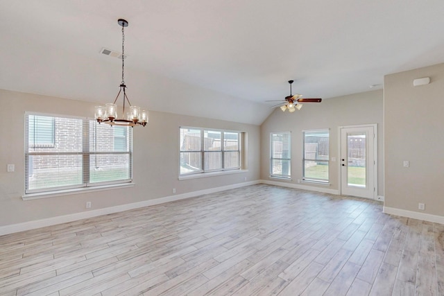 unfurnished room featuring ceiling fan with notable chandelier, lofted ceiling, plenty of natural light, and light hardwood / wood-style floors