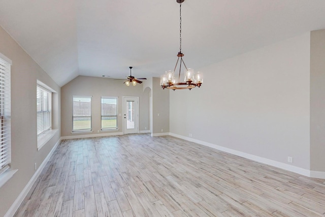 spare room with lofted ceiling, light wood-type flooring, and ceiling fan with notable chandelier