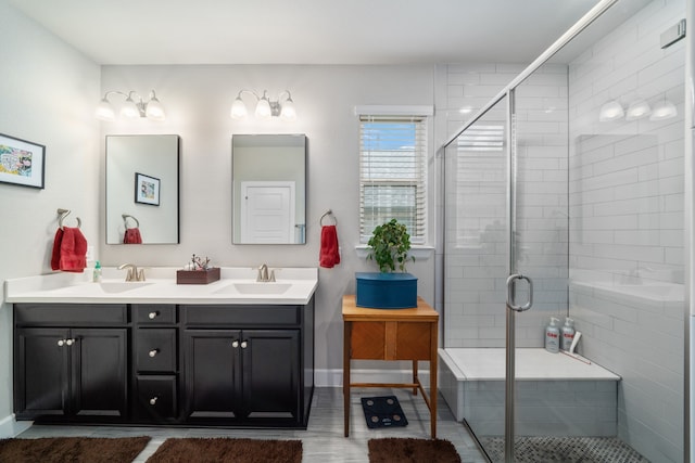 bathroom with vanity and a shower with shower door