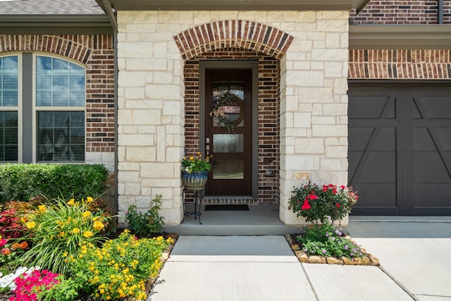 view of exterior entry with a garage