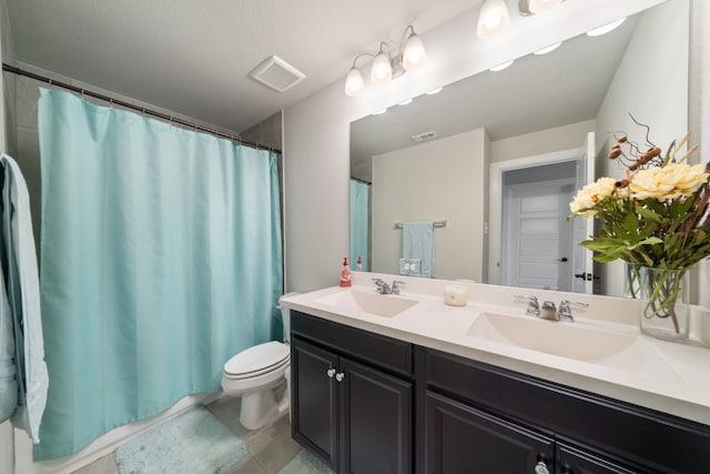 bathroom with vanity, toilet, and a textured ceiling