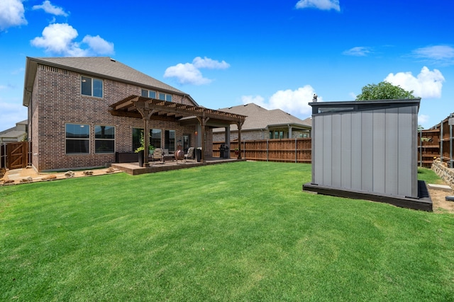 back of property featuring a shed, a pergola, a yard, and a patio