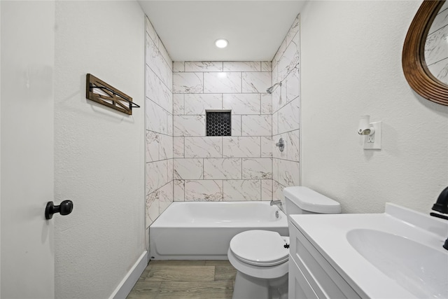 full bathroom with wood-type flooring, vanity, toilet, and tiled shower / bath