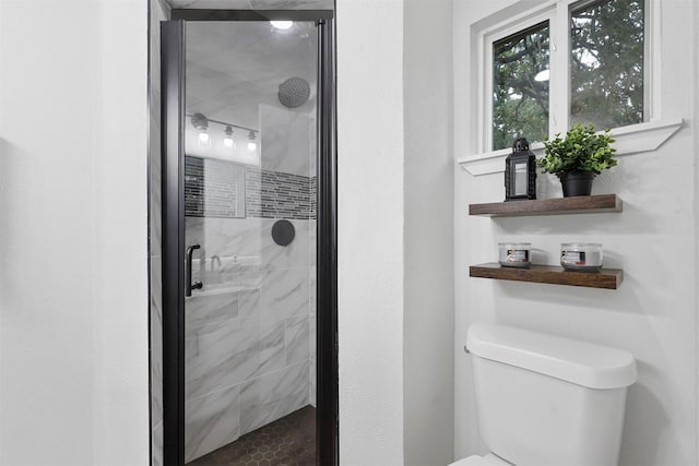 bathroom featuring an enclosed shower and toilet