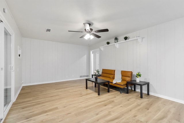 living area featuring ceiling fan and light hardwood / wood-style flooring