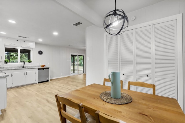 dining room with sink and light wood-type flooring