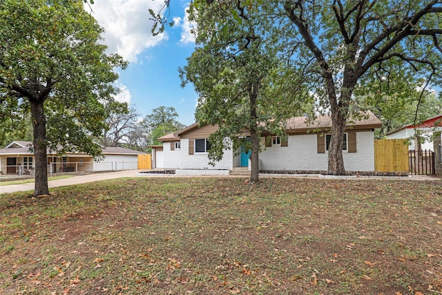 single story home featuring a front yard and a garage